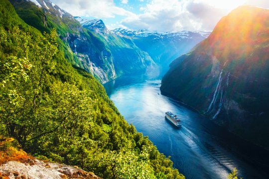Schiff schl&auml;ngelt sich durch einen norwegischen Fjord